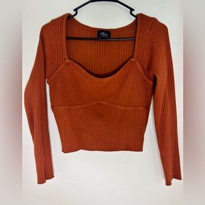 brown shirt, long sleeves, a little short.